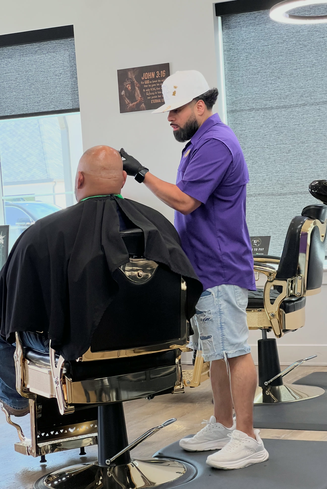 Michael Reynosa carefully detailing a guest’s haircut