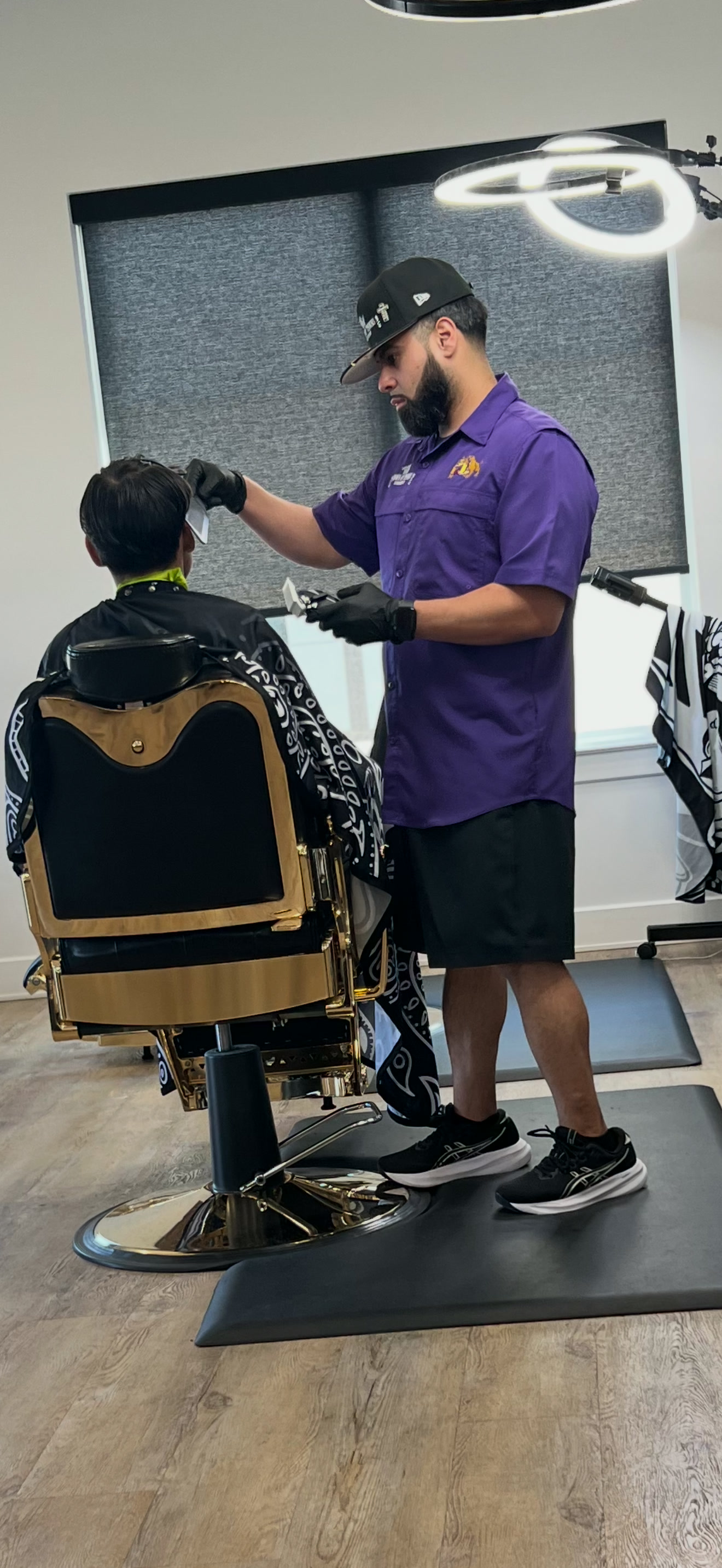 Michael Reynosa giving a young guest a haircut at Crown of Thorns