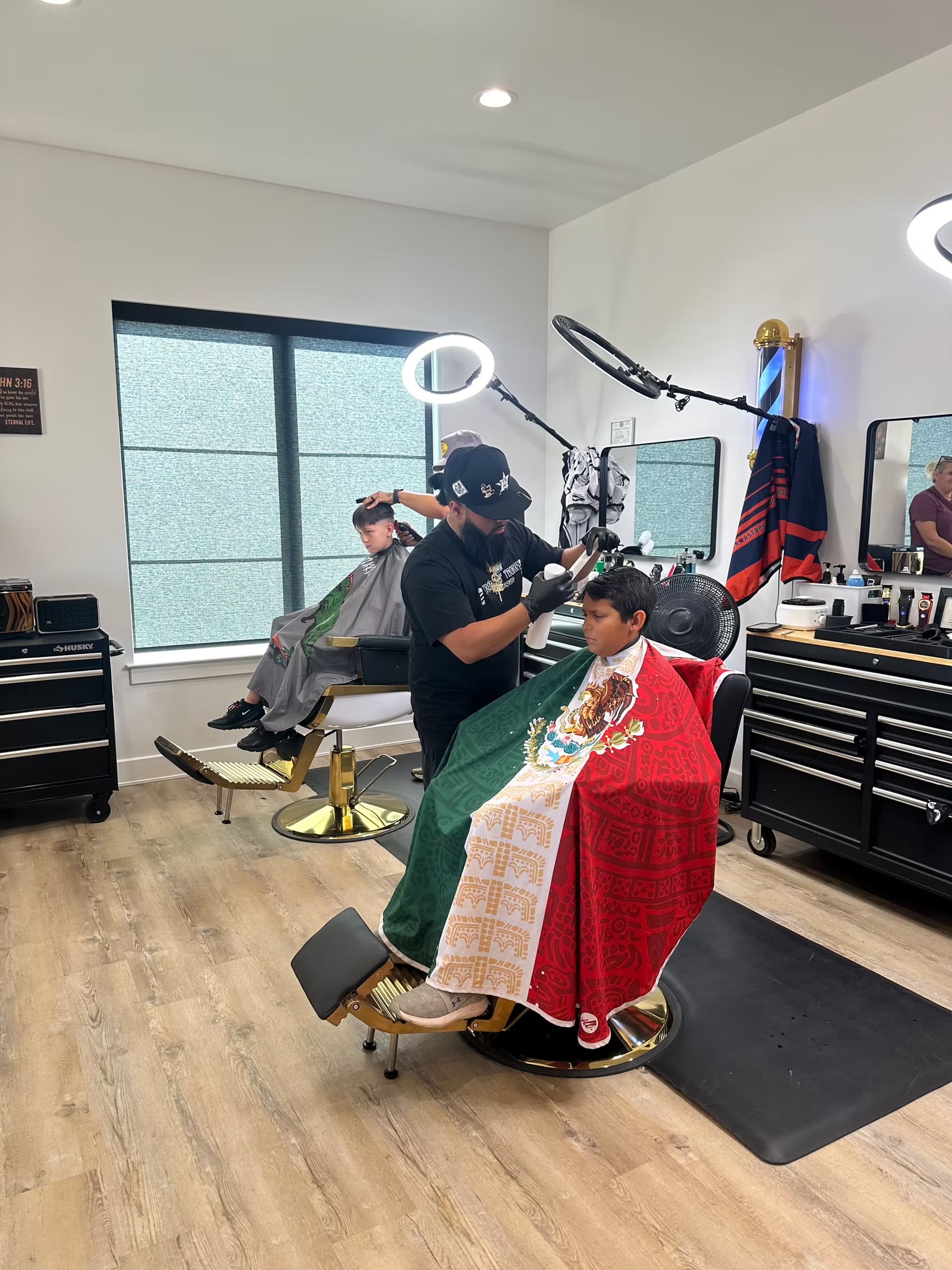 A Crown of Thorns barber carefully finishing a guest’s haircut in Abilene